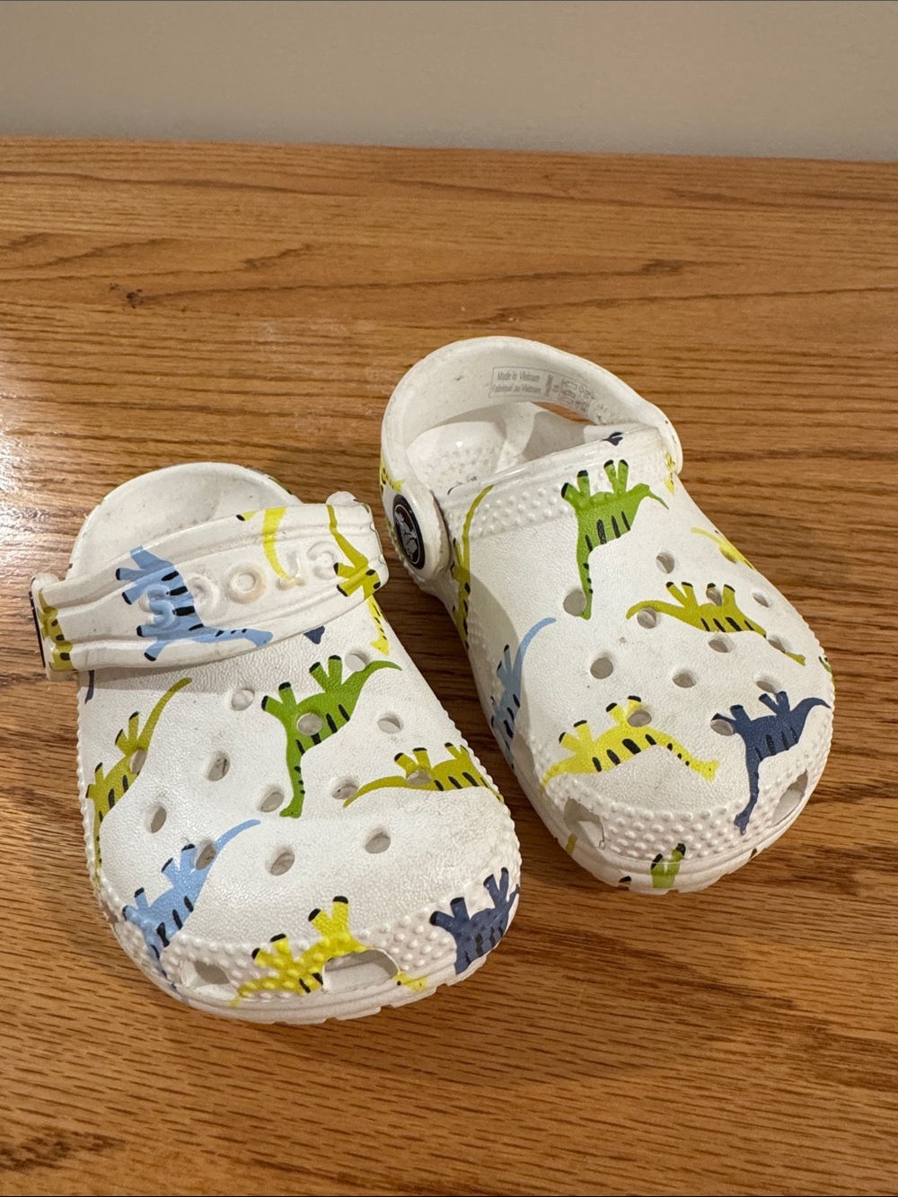 CROCS Kids White Clogs with Green, Blue & Yellow Dino Print